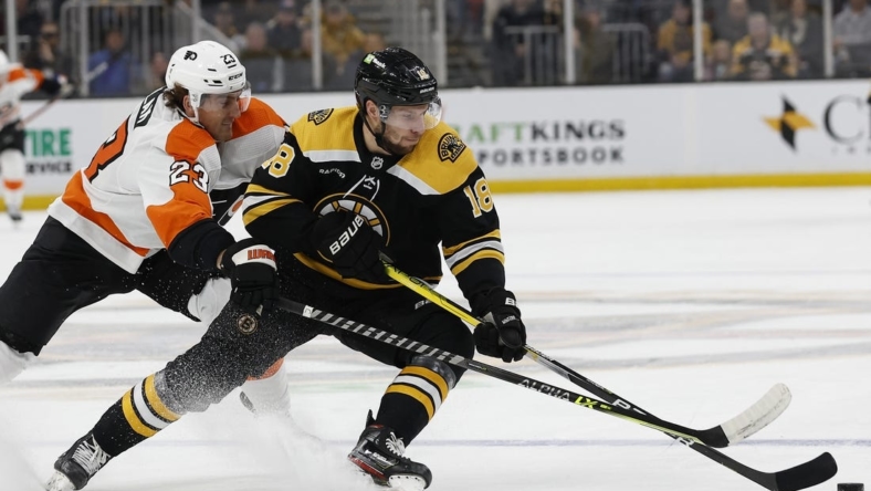 Nov 17, 2022; Boston, Massachusetts, USA; Boston Bruins center Pavel Zacha (18) tries to keep the puck from Philadelphia Flyers center Lukas Sedlak (23) during the first period at TD Garden. Mandatory Credit: Winslow Townson-USA TODAY Sports
