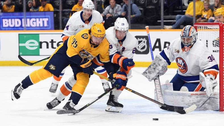 Nov 17, 2022; Nashville, Tennessee, USA; Nashville Predators center Matt Duchene (95) battles for the puck against New York Islanders center Brock Nelson (29) during the first period at Bridgestone Arena. Mandatory Credit: Christopher Hanewinckel-USA TODAY Sports