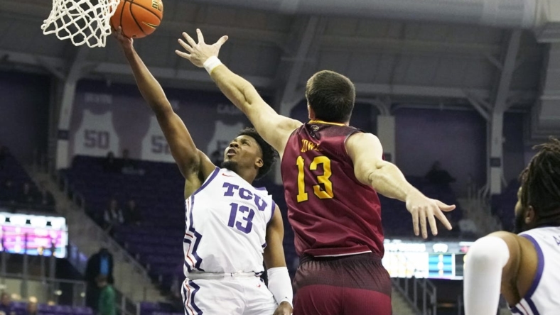 Nov 17, 2022; Fort Worth, Texas, USA; TCU Horned Frogs guard Shahada Wells (13) drives to the basket on Louisiana Monroe Warhawks forward Thomas Howell (13) during the first half at Ed and Rae Schollmaier Arena. Mandatory Credit: Raymond Carlin III-USA TODAY Sports