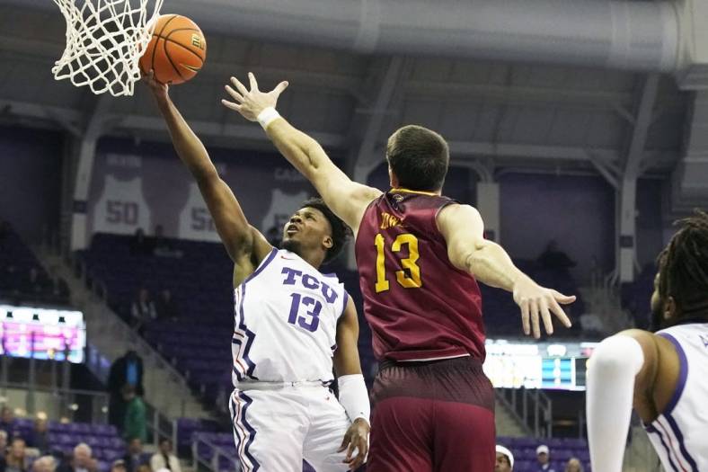 Nov 17, 2022; Fort Worth, Texas, USA; TCU Horned Frogs guard Shahada Wells (13) drives to the basket on Louisiana Monroe Warhawks forward Thomas Howell (13) during the first half at Ed and Rae Schollmaier Arena. Mandatory Credit: Raymond Carlin III-USA TODAY Sports