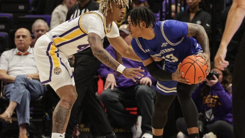 Nov 17, 2022; Baton Rouge, Louisiana, USA; New Orleans Privateers guard Jamond Vincent (13) looks to pass the ball against LSU Tigers guard Adam Miller (44) during the first half at Pete Maravich Assembly Center. Mandatory Credit: Stephen Lew-USA TODAY Sports