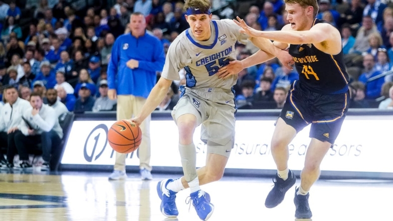 Nov 17, 2022; Omaha, Nebraska, USA; Creighton Bluejays guard Baylor Scheierman (55) drives with the ball against UC Riverside Highlanders forward Wil Tattersall (14) during the first half at CHI Health Center Omaha. Mandatory Credit: Dylan Widger-USA TODAY Sports
