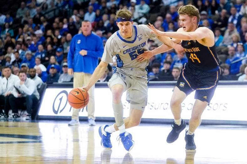 Nov 17, 2022; Omaha, Nebraska, USA; Creighton Bluejays guard Baylor Scheierman (55) drives with the ball against UC Riverside Highlanders forward Wil Tattersall (14) during the first half at CHI Health Center Omaha. Mandatory Credit: Dylan Widger-USA TODAY Sports