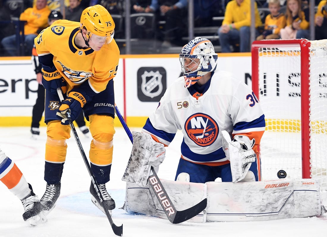 Nov 17, 2022; Nashville, Tennessee, USA; Nashville Predators center Juuso Parssinen (75) redirects a shot past New York Islanders goaltender Ilya Sorokin (30) for a goal during the third period at Bridgestone Arena. Mandatory Credit: Christopher Hanewinckel-USA TODAY Sports