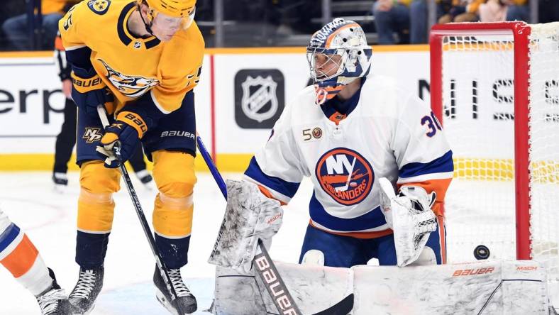 Nov 17, 2022; Nashville, Tennessee, USA; Nashville Predators center Juuso Parssinen (75) redirects a shot past New York Islanders goaltender Ilya Sorokin (30) for a goal during the third period at Bridgestone Arena. Mandatory Credit: Christopher Hanewinckel-USA TODAY Sports