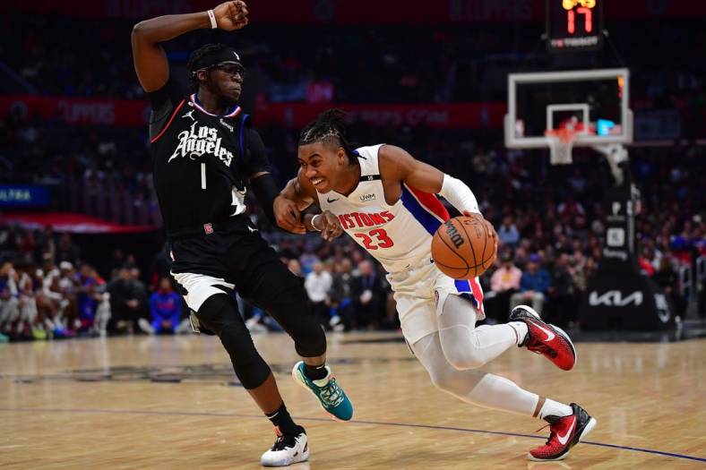 Nov 17, 2022; Los Angeles, California, USA; Detroit Pistons guard Jaden Ivey (23) moves to the basket against Los Angeles Clippers guard Reggie Jackson (1) during the second half at Crypto.com Arena. Mandatory Credit: Gary A. Vasquez-USA TODAY Sports
