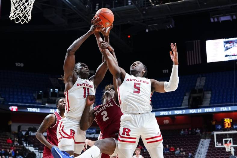 Nov 18, 2022; Uncasville, Connecticut, USA;  Rutgers Scarlet Knights center Clifford Omoruyi (11) and Rutgers Scarlet Knights forward Aundre Hyatt (5) grab a rebound against the Temple Owls during the first half at Mohegan Sun Arena. Mandatory Credit: Gregory Fisher-USA TODAY Sports
