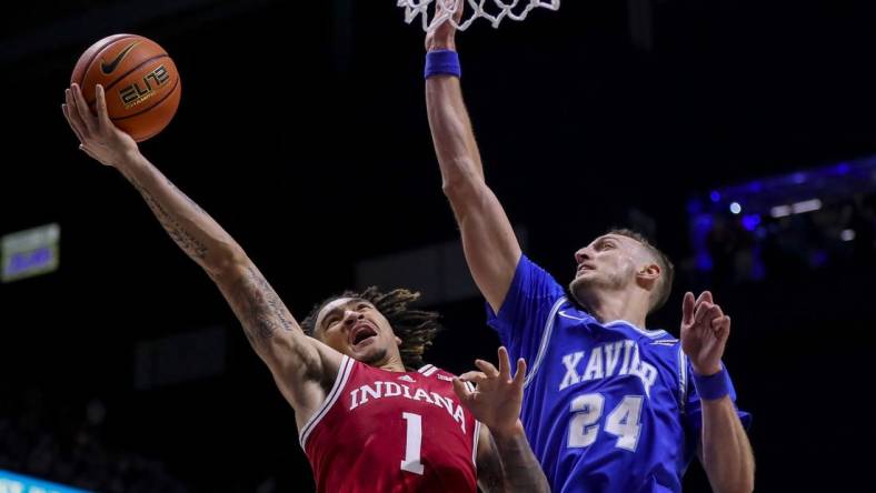 Nov 18, 2022; Cincinnati, Ohio, USA; Indiana Hoosiers guard Jalen Hood-Schifino (1) drives to the basket against Xavier Musketeers forward Jack Nunge (24) in the first half at Cintas Center. Mandatory Credit: Katie Stratman-USA TODAY Sports