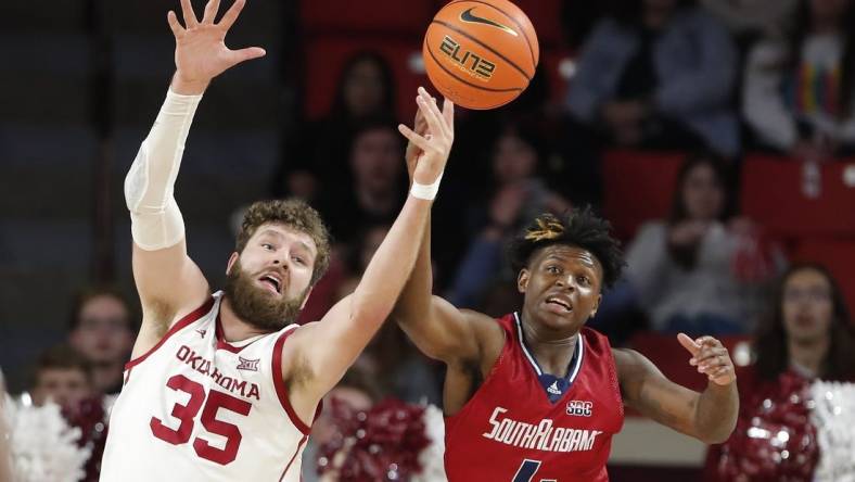 Nov 18, 2022; Norman, Oklahoma, USA; Oklahoma Sooners forward Tanner Groves (35) and South Alabama Jaguars guard Isaiah Moore (4) reach for a loose ball during the first half at Lloyd Noble Center. Mandatory Credit: Alonzo Adams-USA TODAY Sports