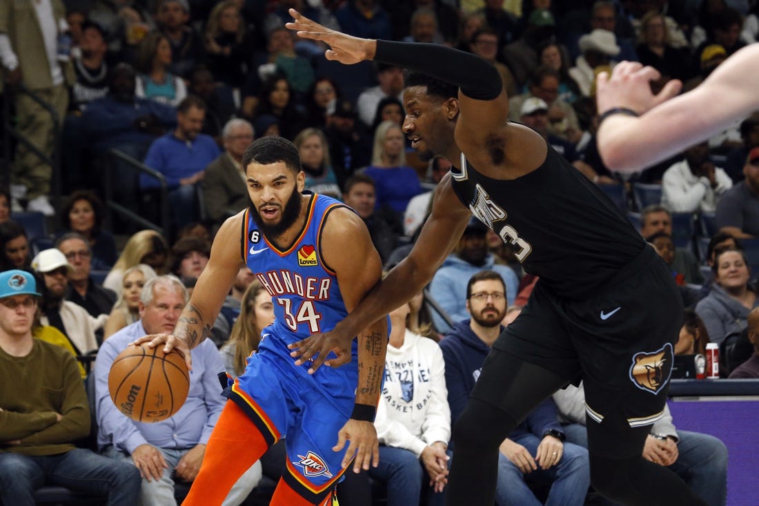 Nov 18, 2022; Memphis, Tennessee, USA; Oklahoma City Thunder forward Kenrich Williams (34) drives to the basket as Memphis Grizzlies forward Jaren Jackson Jr. (13) defends during the second quarter at FedExForum. Mandatory Credit: Petre Thomas-USA TODAY Sports