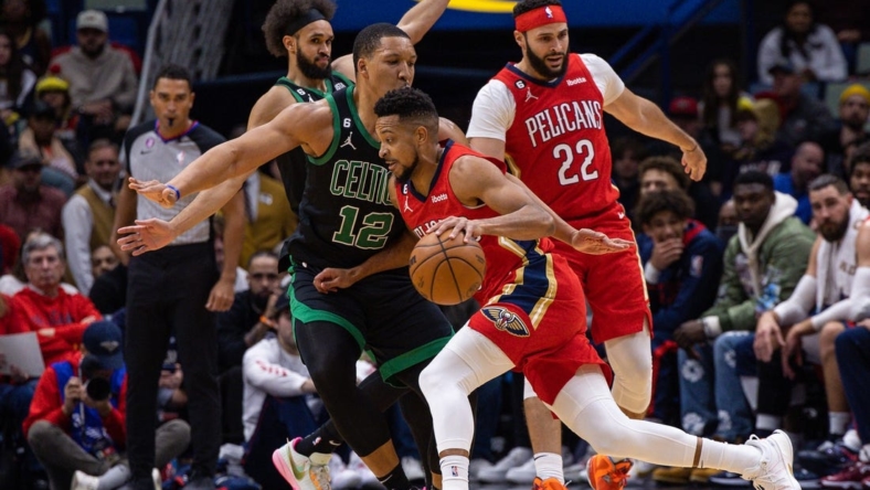 Nov 18, 2022; New Orleans, Louisiana, USA;  New Orleans Pelicans guard CJ McCollum (3) dribbles against Boston Celtics forward Grant Williams (12) during the first half at Smoothie King Center. Mandatory Credit: Stephen Lew-USA TODAY Sports