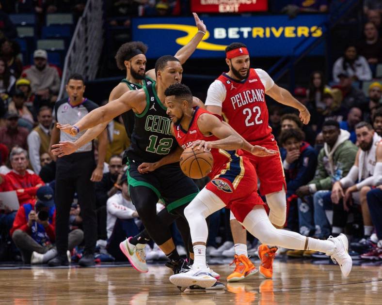 Nov 18, 2022; New Orleans, Louisiana, USA;  New Orleans Pelicans guard CJ McCollum (3) dribbles against Boston Celtics forward Grant Williams (12) during the first half at Smoothie King Center. Mandatory Credit: Stephen Lew-USA TODAY Sports