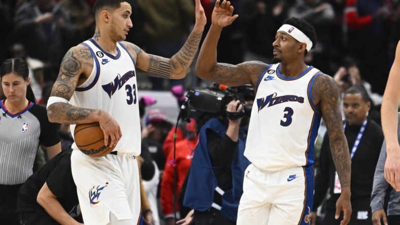 Nov 18, 2022; Washington, District of Columbia, USA; Washington Wizards guard Bradley Beal (3) and forward Kyle Kuzma (33) celebrate after the game against the Miami Heat at Capital One Arena. Mandatory Credit: Brad Mills-USA TODAY Sports