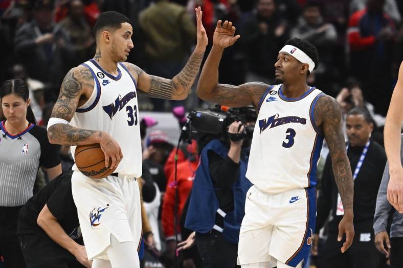Nov 18, 2022; Washington, District of Columbia, USA; Washington Wizards guard Bradley Beal (3) and forward Kyle Kuzma (33) celebrate after the game against the Miami Heat at Capital One Arena. Mandatory Credit: Brad Mills-USA TODAY Sports