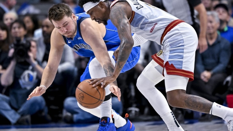 Nov 18, 2022; Dallas, Texas, USA; Dallas Mavericks guard Luka Doncic (77) and Denver Nuggets guard Kentavious Caldwell-Pope (5) battle for the loose ball during the second quarter at the American Airlines Center. Mandatory Credit: Jerome Miron-USA TODAY Sports