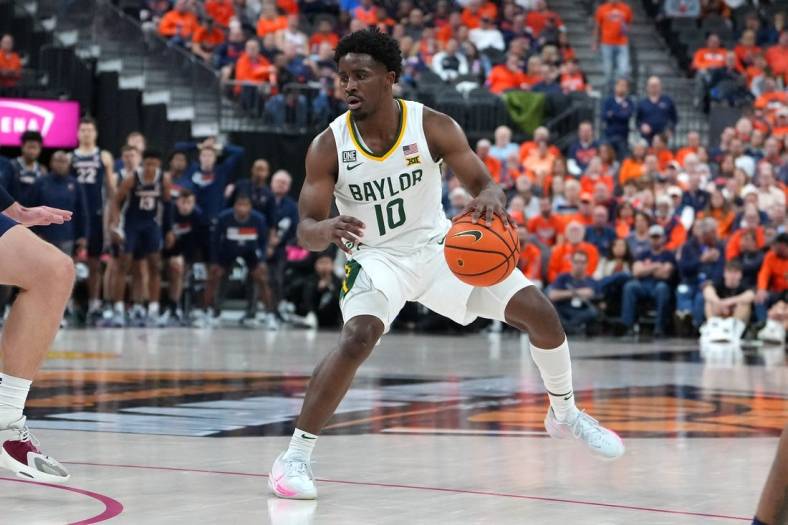 Nov 18, 2022; Las Vegas, Nevada, USA;  Baylor Bears guard Adam Flagler (10) dribbles against the Virginia Cavaliers during the second half at T-Mobile Arena. Mandatory Credit: Stephen R. Sylvanie-USA TODAY Sports