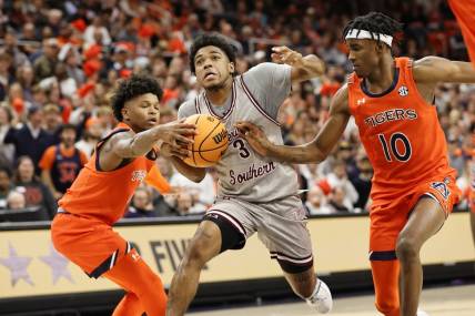 Nov 18, 2022; Auburn, Alabama, USA;  Auburn Tigers guards Wendell Green Jr. (1) and Chance Westry (10) strip the ball from Texas Southern Tigers guard PJ Henry (3) during the first half at Neville Arena. Mandatory Credit: John Reed-USA TODAY Sports