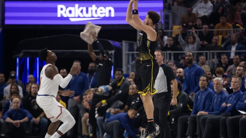 Nov 18, 2022; San Francisco, California, USA; Golden State Warriors guard Klay Thompson (11) shoots a 3-point basket over New York Knicks guard RJ Barrett (9) during the first quarter at Chase Center. Mandatory Credit: D. Ross Cameron-USA TODAY Sports