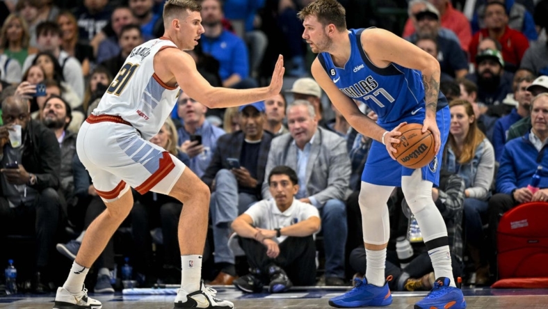 Nov 18, 2022; Dallas, Texas, USA; Denver Nuggets forward Vlatko Cancar (31) defends against Dallas Mavericks guard Luka Doncic (77) during the second half at the American Airlines Center. Mandatory Credit: Jerome Miron-USA TODAY Sports