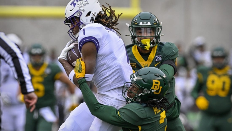 Nov 19, 2022; Waco, Texas, USA; TCU Horned Frogs wide receiver Quentin Johnston (1) catches a pass for a first down against the Baylor Bears as cornerback Mark Milton (3) defends during the first quarter at McLane Stadium. Mandatory Credit: Jerome Miron-USA TODAY Sports
