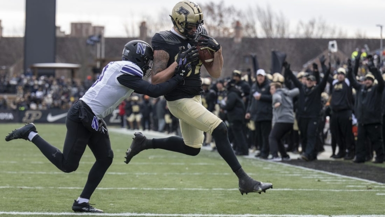 Nov 19, 2022; West Lafayette, Indiana, USA;  Purdue Boilermakers tight end Payne Durham (87) catches a pass that results in a touchdown against Northwestern Wildcats defensive back Jeremiah Lewis (9) during the second quarter  at Ross-Ade Stadium. Mandatory Credit: Marc Lebryk-USA TODAY Sports