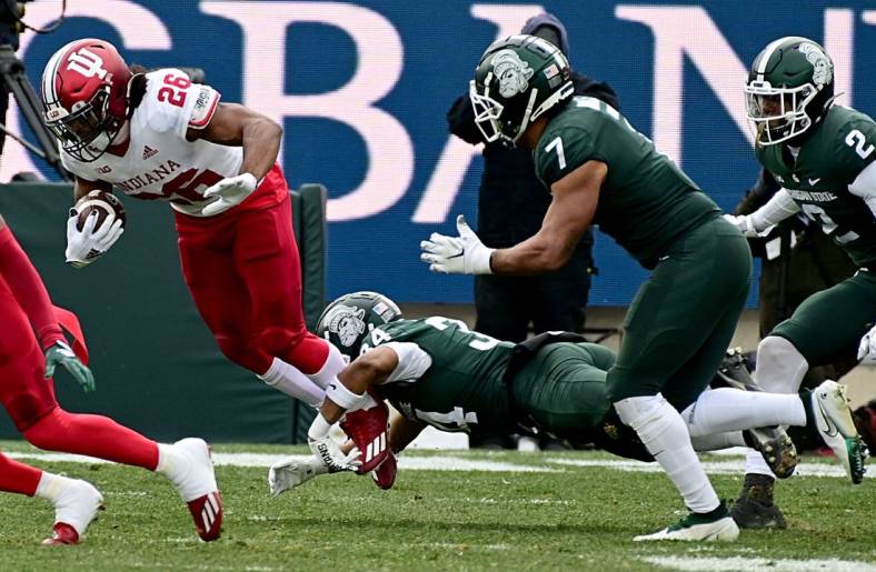 Nov 19, 2022; East Lansing, Michigan, USA;  Michigan State Spartans safety Khalil Majeed (34) tackles Indiana Hoosiers running back Josh Henderson (26) in the second quarter at Spartan Stadium. Mandatory Credit: Dale Young-USA TODAY Sports