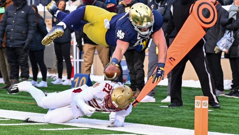 Nov 19, 2022; South Bend, Indiana, USA; Notre Dame Fighting Irish tight end Michael Mayer (87) dives for the pylon as Boston College Eagles defensive back Josh DeBerry (21) defends in the first quarter at Notre Dame Stadium. Mandatory Credit: Matt Cashore-USA TODAY Sports