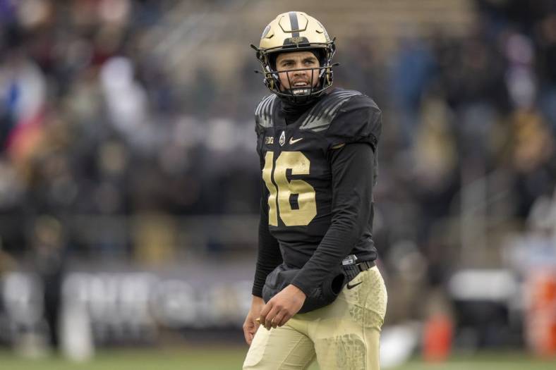 Nov 19, 2022; West Lafayette, Indiana, USA;  Purdue Boilermakers quarterback Aidan O'Connell (16) looks up at the scoreboard after calling a timeout during the second half against the Northwestern Wildcats at Ross-Ade Stadium. Mandatory Credit: Marc Lebryk-USA TODAY Sports