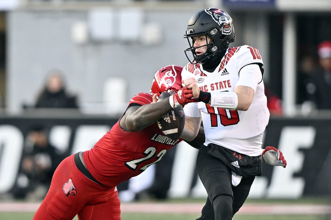 Nov 19, 2022; Louisville, Kentucky, USA;  Louisville Cardinals linebacker Yasir Abdullah (22) sacks North Carolina State Wolfpack quarterback Ben Finley (10) during the second quarter at Cardinal Stadium. Mandatory Credit: Jamie Rhodes-USA TODAY Sports