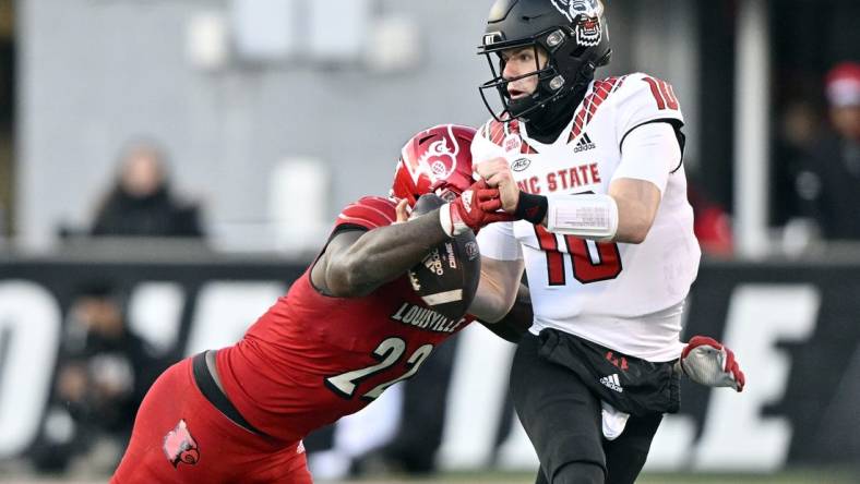 Nov 19, 2022; Louisville, Kentucky, USA;  Louisville Cardinals linebacker Yasir Abdullah (22) sacks North Carolina State Wolfpack quarterback Ben Finley (10) during the second quarter at Cardinal Stadium. Mandatory Credit: Jamie Rhodes-USA TODAY Sports