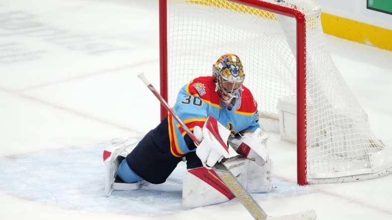 Nov 19, 2022; Sunrise, Florida, USA; Florida Panthers goaltender Spencer Knight (30) makes a stick save during the third period against the Calgary Flames at FLA Live Arena. Mandatory Credit: Jasen Vinlove-USA TODAY Sports