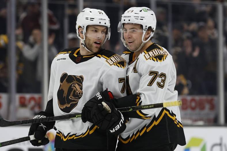 Nov 19, 2022; Boston, Massachusetts, USA; Boston Bruins defenseman Charlie McAvoy (73) congratulates left wing Taylor Hall (71) after his goal against the Chicago Blackhawks during the third period at TD Garden. Mandatory Credit: Winslow Townson-USA TODAY Sports