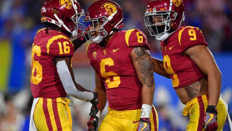 Nov 19, 2022; Pasadena, California, USA; Southern California Trojans running back Austin Jones (6) celebrates his touchdown scored against the UCLA Bruins with wide receiver Tahj Washington (16) and wide receiver Michael Jackson III (9) during the first half at the Rose Bowl. Mandatory Credit: Gary A. Vasquez-USA TODAY Sports