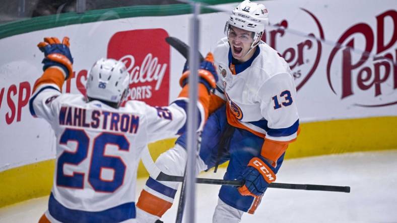 Nov 19, 2022; Dallas, Texas, USA; New York Islanders right wing Oliver Wahlstrom (26) and center Mathew Barzal (13) celebrates a goal scored by Barzal against the Dallas Stars during the second period at the American Airlines Center. Mandatory Credit: Jerome Miron-USA TODAY Sports