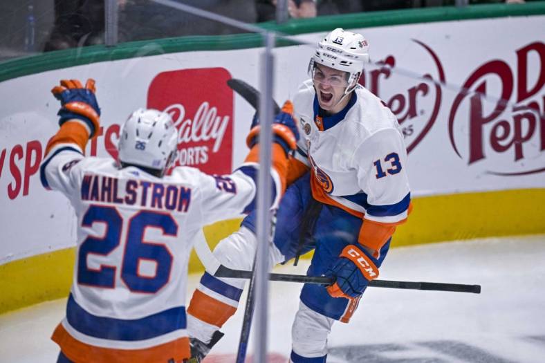 Nov 19, 2022; Dallas, Texas, USA; New York Islanders right wing Oliver Wahlstrom (26) and center Mathew Barzal (13) celebrates a goal scored by Barzal against the Dallas Stars during the second period at the American Airlines Center. Mandatory Credit: Jerome Miron-USA TODAY Sports