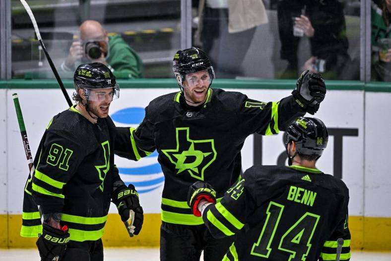 Nov 19, 2022; Dallas, Texas, USA; Dallas Stars center Tyler Seguin (91) and center Radek Faksa (12) and left wing Jamie Benn (14) celebrates a goal scored by Faksa against the New York Islanders during the second period at the American Airlines Center. Mandatory Credit: Jerome Miron-USA TODAY Sports