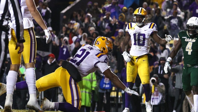 Nov 19, 2022; Baton Rouge, Louisiana, USA;  LSU Tigers quarterback Tavion Faulk (12) falls into the end zone for a touchdown against the UAB Blazers during the first half at Tiger Stadium. Mandatory Credit: Stephen Lew-USA TODAY Sports