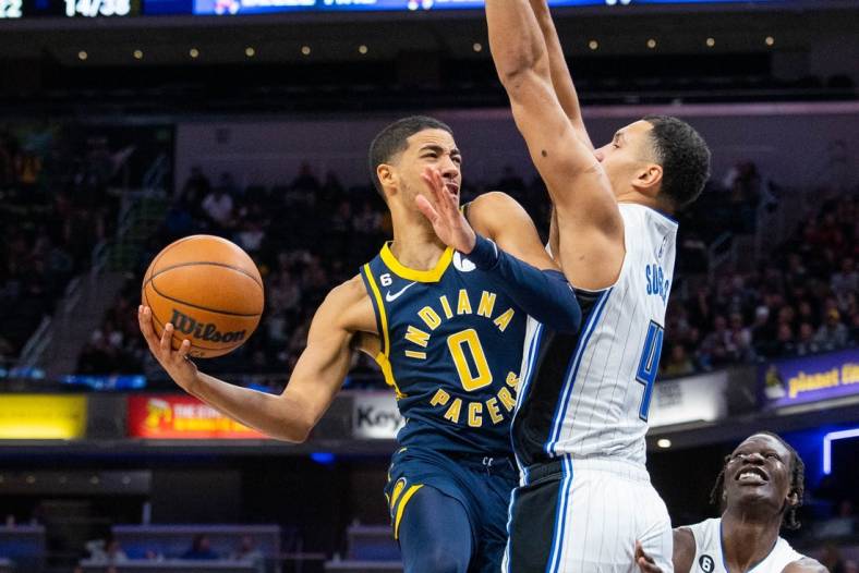 Nov 19, 2022; Indianapolis, Indiana, USA; Indiana Pacers guard Tyrese Haliburton (0) shoots the ball against Orlando Magic guard Jalen Suggs (4) in the second half at Gainbridge Fieldhouse. Mandatory Credit: Trevor Ruszkowski-USA TODAY Sports