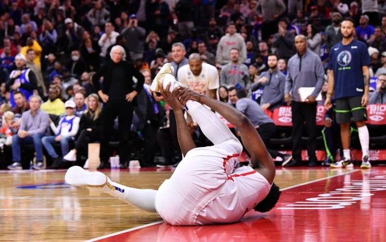 Nov 19, 2022; Philadelphia, Pennsylvania, USA; Philadelphia 76ers center Joel Embiid (21) grabs his ankle after falling against the Minnesota Timberwolves in the fourth quarter at Wells Fargo Center. Mandatory Credit: Kyle Ross-USA TODAY Sports