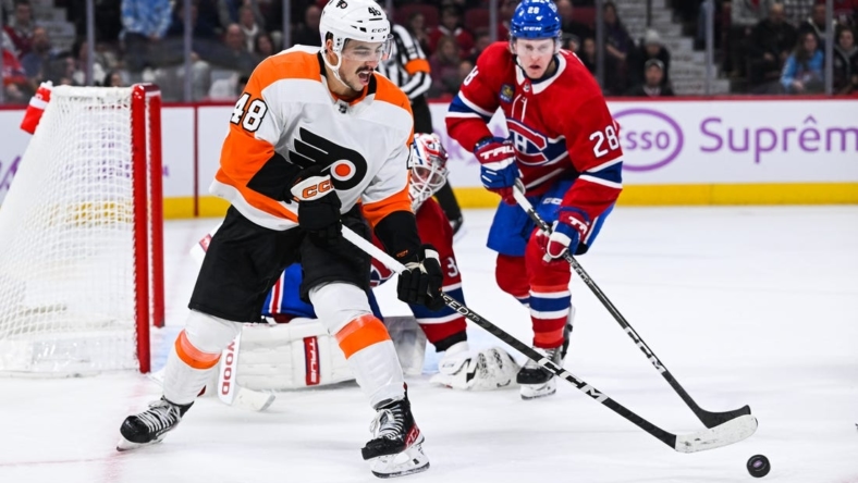 Nov 19, 2022; Montreal, Quebec, CAN; Philadelphia Flyers center Morgan Frost (48) plays the puck against the Philadelphia Flyers during the second period at Bell Centre. Mandatory Credit: David Kirouac-USA TODAY Sports