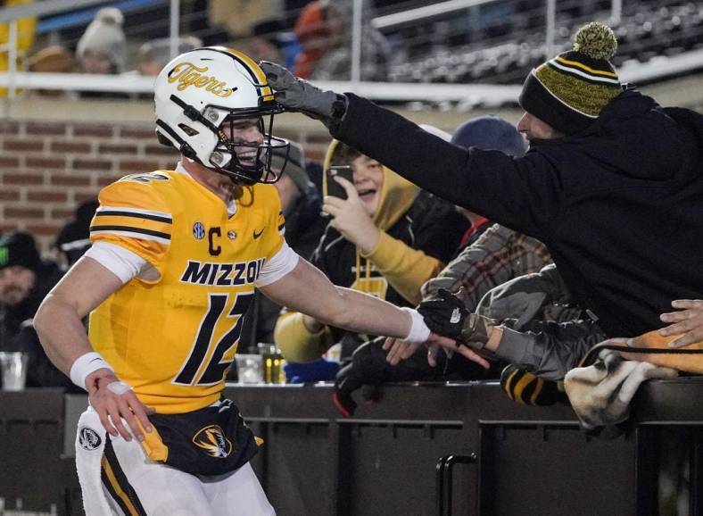 Nov 19, 2022; Columbia, Missouri, USA; Missouri Tigers quarterback Brady Cook (12) celebrates with fans after a score against the New Mexico State Aggies during the second half at Faurot Field at Memorial Stadium. Mandatory Credit: Denny Medley-USA TODAY Sports