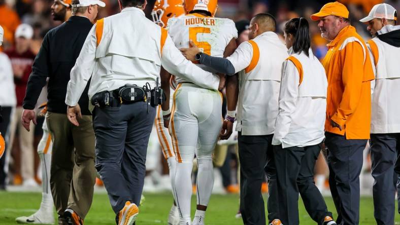 Nov 19, 2022; Columbia, South Carolina, USA; Tennessee Volunteers quarterback Hendon Hooker (5) is assisted off the field after suffering an apparent injury against the South Carolina Gamecocks in the second half at Williams-Brice Stadium. Mandatory Credit: Jeff Blake-USA TODAY Sports