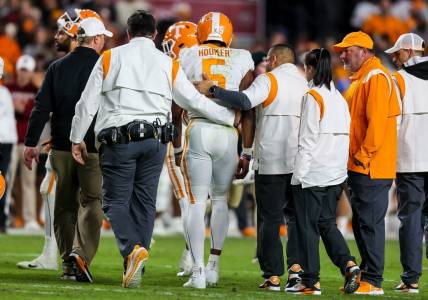 Nov 19, 2022; Columbia, South Carolina, USA; Tennessee Volunteers quarterback Hendon Hooker (5) is assisted off the field after suffering an apparent injury against the South Carolina Gamecocks in the second half at Williams-Brice Stadium. Mandatory Credit: Jeff Blake-USA TODAY Sports