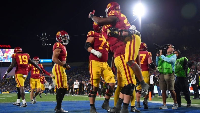 Nov 19, 2022; Pasadena, California, USA; Southern California Trojans running back Darwin Barlow (22) celebrates his touchdown scored against the UCLA Bruins with offensive lineman Bobby Haskins (70) during the second half at the Rose Bowl. Mandatory Credit: Gary A. Vasquez-USA TODAY Sports
