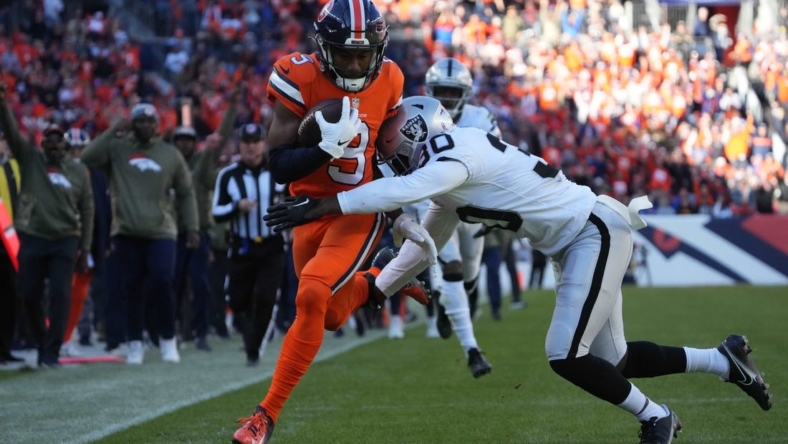 Nov 20, 2022; Denver, Colorado, USA; Las Vegas Raiders safety Duron Harmon (30) tackles Denver Broncos wide receiver Kendall Hinton (9) in the first quarter at Empower Field at Mile High. Mandatory Credit: Ron Chenoy-USA TODAY Sports