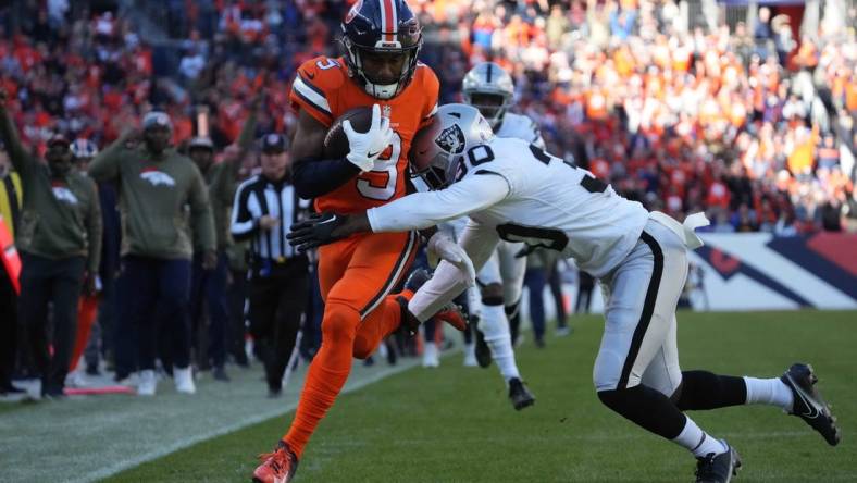 Nov 20, 2022; Denver, Colorado, USA; Las Vegas Raiders safety Duron Harmon (30) tackles Denver Broncos wide receiver Kendall Hinton (9) in the first quarter at Empower Field at Mile High. Mandatory Credit: Ron Chenoy-USA TODAY Sports