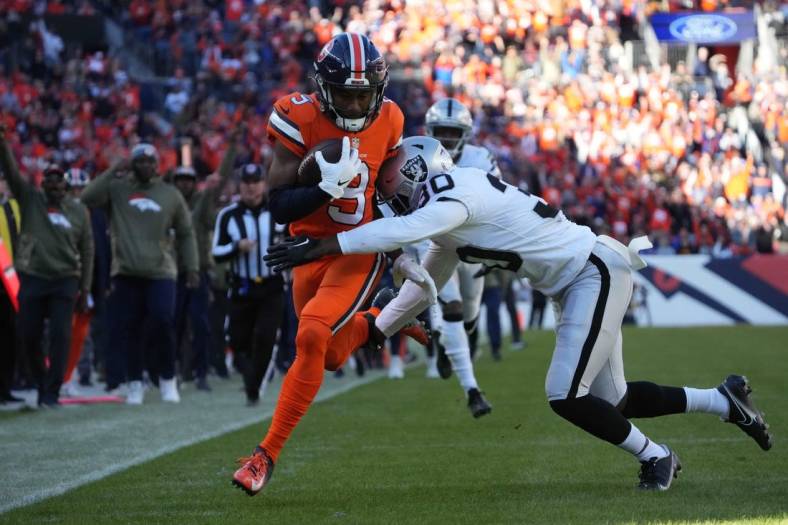 Nov 20, 2022; Denver, Colorado, USA; Las Vegas Raiders safety Duron Harmon (30) tackles Denver Broncos wide receiver Kendall Hinton (9) in the first quarter at Empower Field at Mile High. Mandatory Credit: Ron Chenoy-USA TODAY Sports