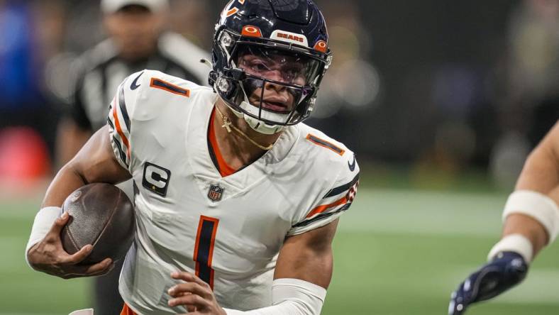 Nov 20, 2022; Atlanta, Georgia, USA; Chicago Bears quarterback Justin Fields (1) runs with the ball against the Atlanta Falcons at Mercedes-Benz Stadium. Mandatory Credit: Dale Zanine-USA TODAY Sports