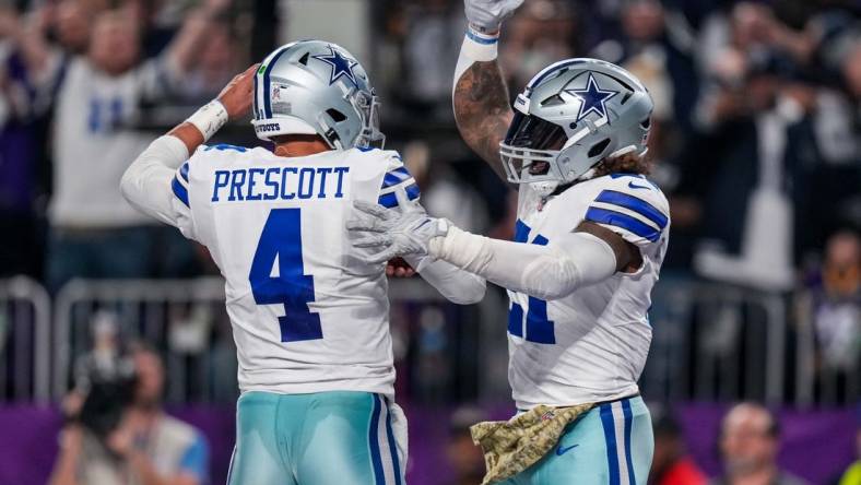 Nov 20, 2022; Minneapolis, Minnesota, USA; Dallas Cowboys quarterback Dak Prescott (4) and running back Ezekiel Elliott (21) celebrate a touchdown during the third quarter against the Minnesota Vikings at U.S. Bank Stadium. Mandatory Credit: Brace Hemmelgarn-USA TODAY Sports