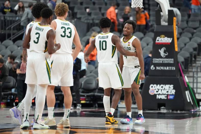 Nov 20, 2022; Las Vegas, Nevada, USA; Baylor Bears guard LJ Cryer (4) celebrates with Baylor Bears guard Adam Flagler (10) after the Bears defeated the UCLA Bruins 80-75 at T-Mobile Arena. Mandatory Credit: Stephen R. Sylvanie-USA TODAY Sports